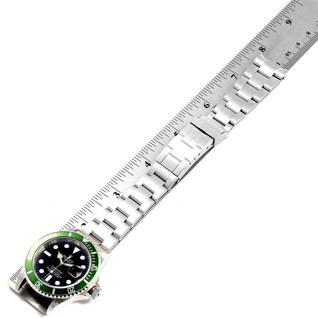 This image shows a top-down angle of a Rolex Submariner 16610LV Men's Stainless Steel Black Dial 16610LV Men's Stainless Steel Black Dial watch with its stainless steel bracelet stretched along a ruler.