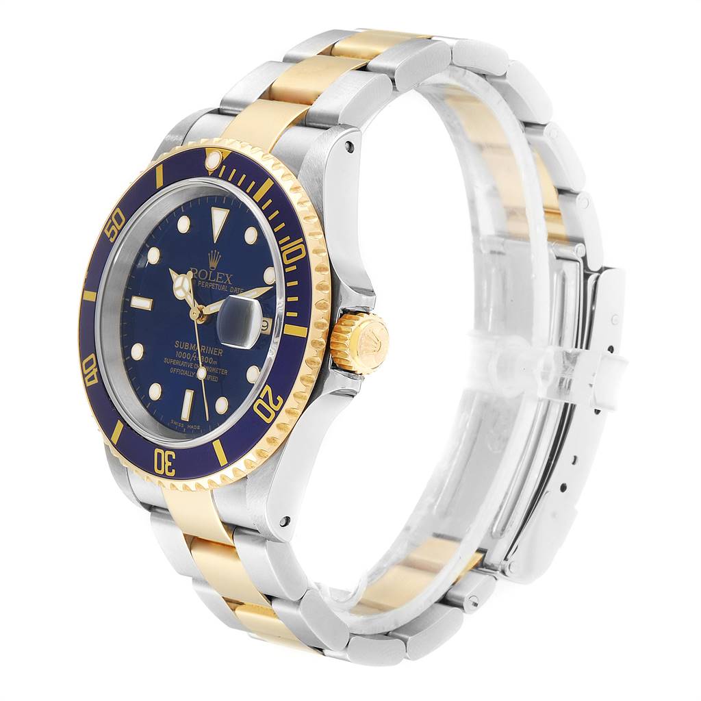 The image shows a Rolex Submariner 16613 Men
s Steel and Gold (two tone) Blue Dial 16613 Men
s Steel and Gold (two tone) Blue Dial watch from a front-side angle, highlighting its dial, bezel, case, and bracelet.