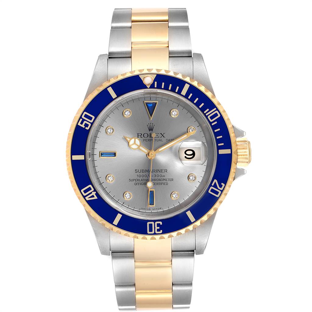 The image shows a Rolex Submariner 16613 Men
s Steel and Gold (two tone) Grey Dial 16613 Men
s Steel and Gold (two tone) Grey Dial watch from a front angle, highlighting its gold-and-silver bracelet, blue bezel, and grey dial.