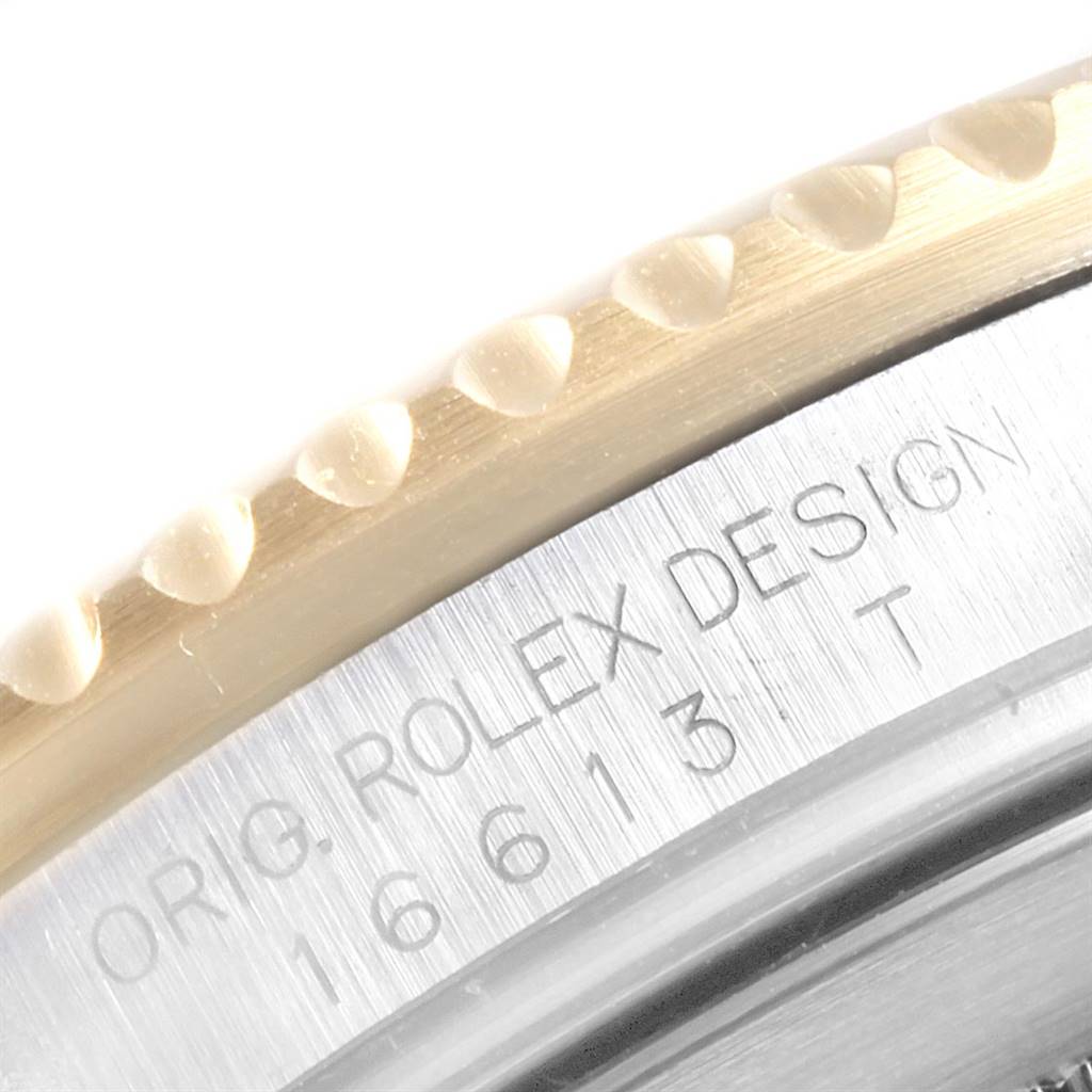 The image shows a close-up view of the bezel and serial number engraving on a Rolex Submariner 16613 Men
s Steel and Gold (two tone) Grey Dial 16613 Men
s Steel and Gold (two tone) Grey Dial watch.