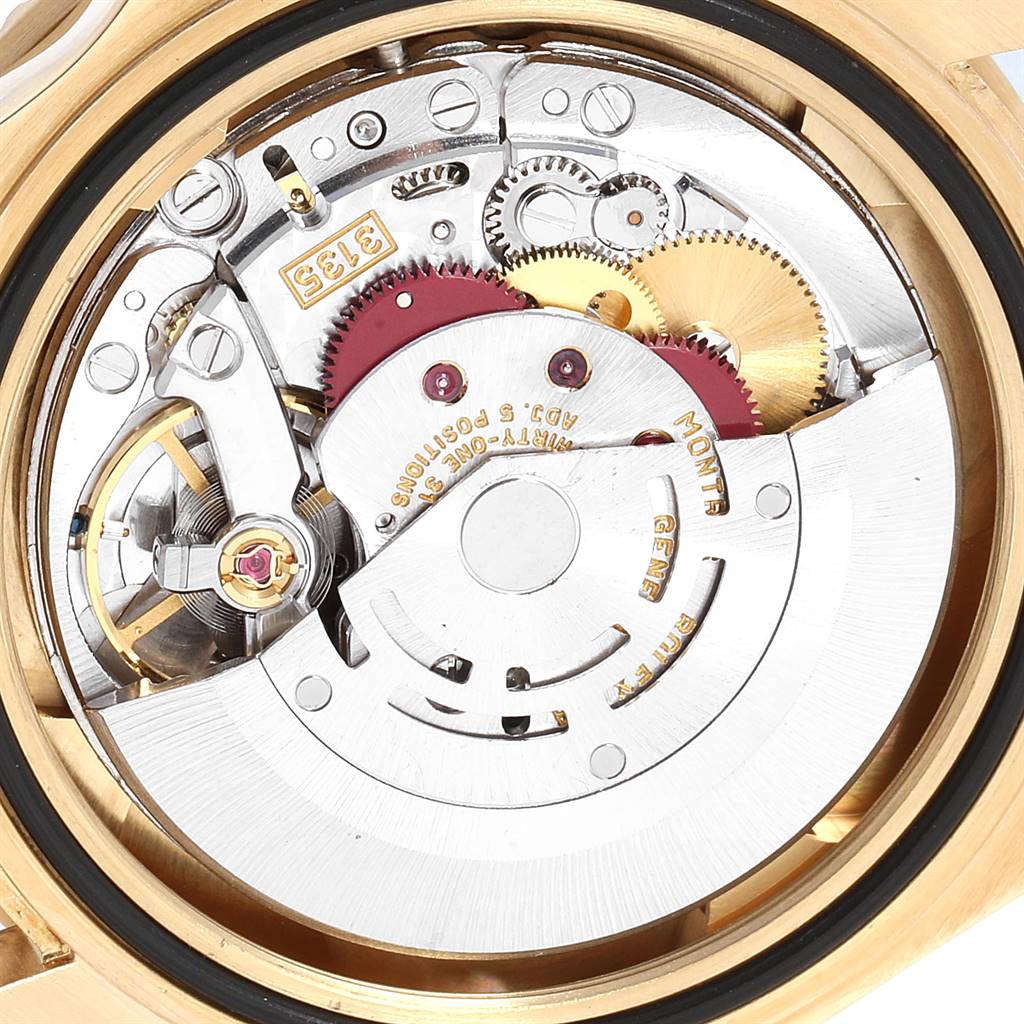 This image shows the intricate internal mechanics and gears of a Rolex Submariner 16618 Men
s Yellow Gold Black Dial 16618 Men
s Yellow Gold Black Dial watch from a close-up angle.
