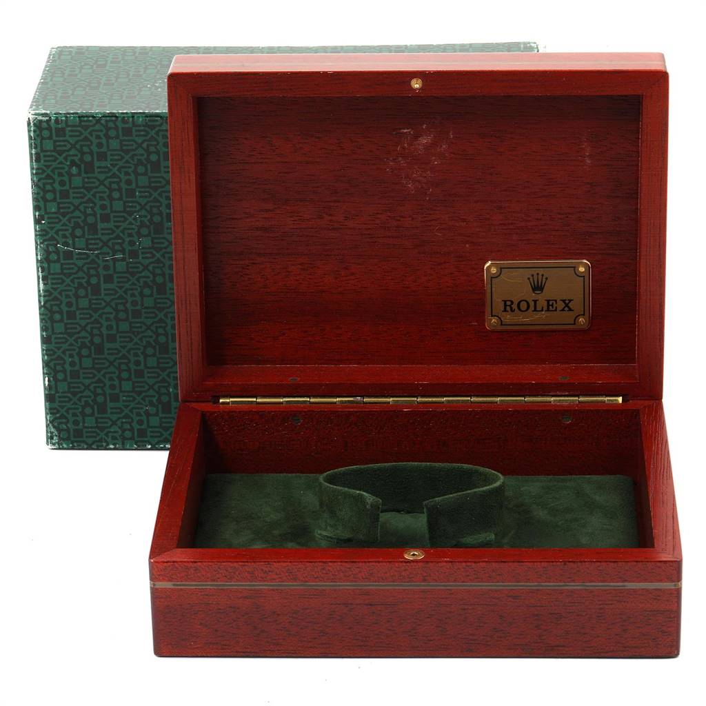 The image shows an open wooden box with a green interior for a Rolex Submariner 16618 Men
s Yellow Gold Black Dial 16618 Men
s Yellow Gold Black Dial watch, along with its green outer packaging.