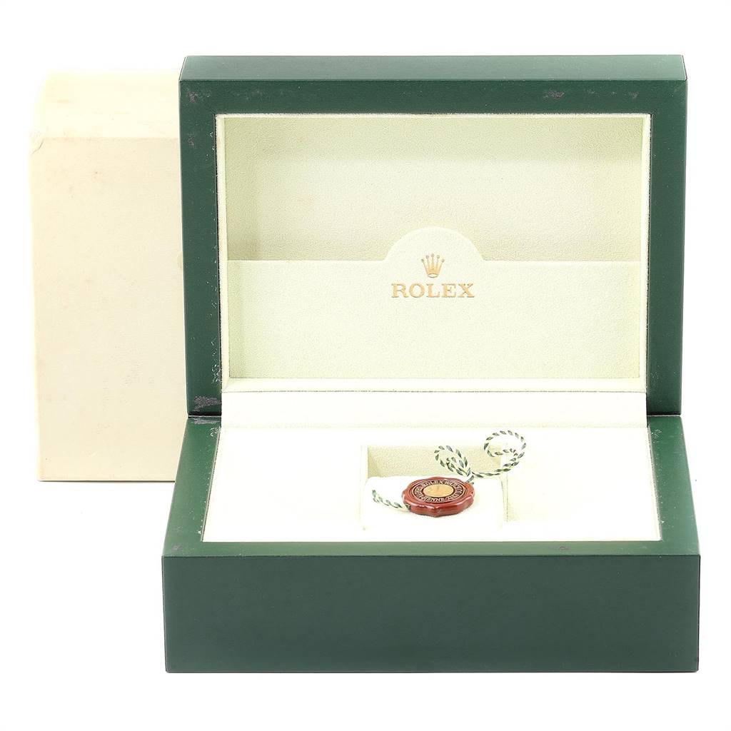 The image shows an open Rolex Submariner 16613 Men's Steel and Gold (two tone) Black Dial 16613 Men's Steel and Gold (two tone) Black Dial watch box with a green exterior, beige interior, and a green and white string tag inside.