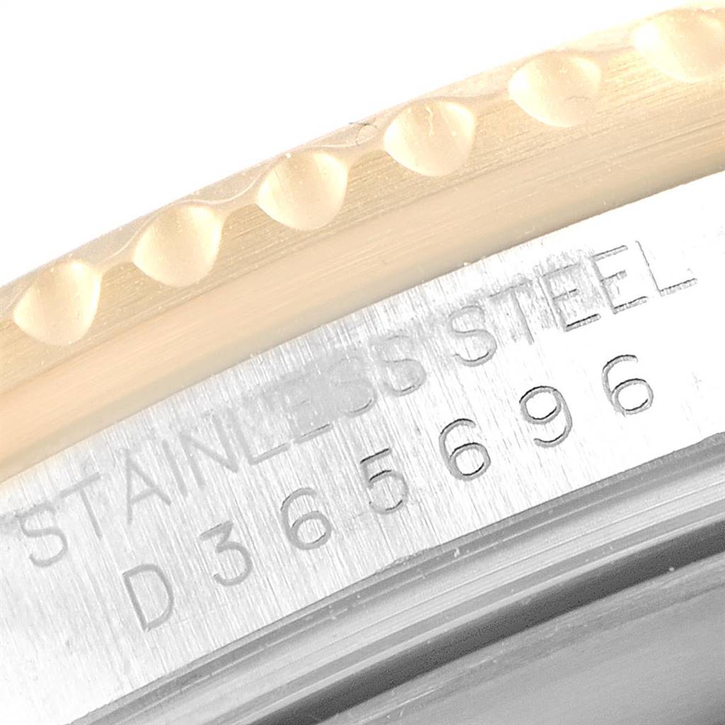 This image shows a close-up view of the bezel and case side, with serial number engraving, of a Rolex Submariner 16613 Men
s Steel and Gold (two tone) Champagne Dial 16613 Men
s Steel and Gold (two tone) Champagne Dial watch.