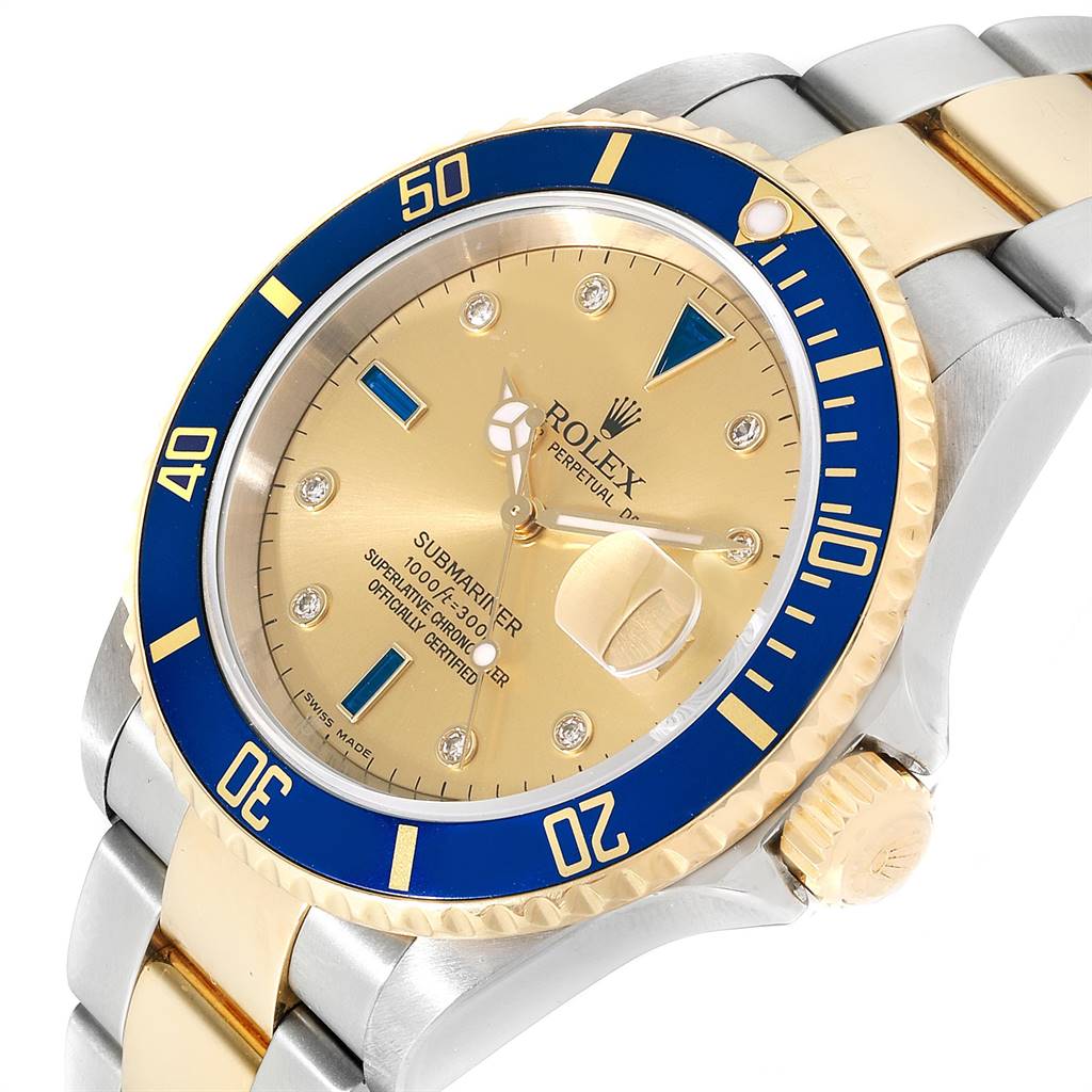 The image shows a close-up view of the Rolex Submariner 16613 Men
s Steel and Gold (two tone) Champagne Dial 16613 Men
s Steel and Gold (two tone) Champagne Dial watch, highlighting the gold and blue bezel, crown, and dial.