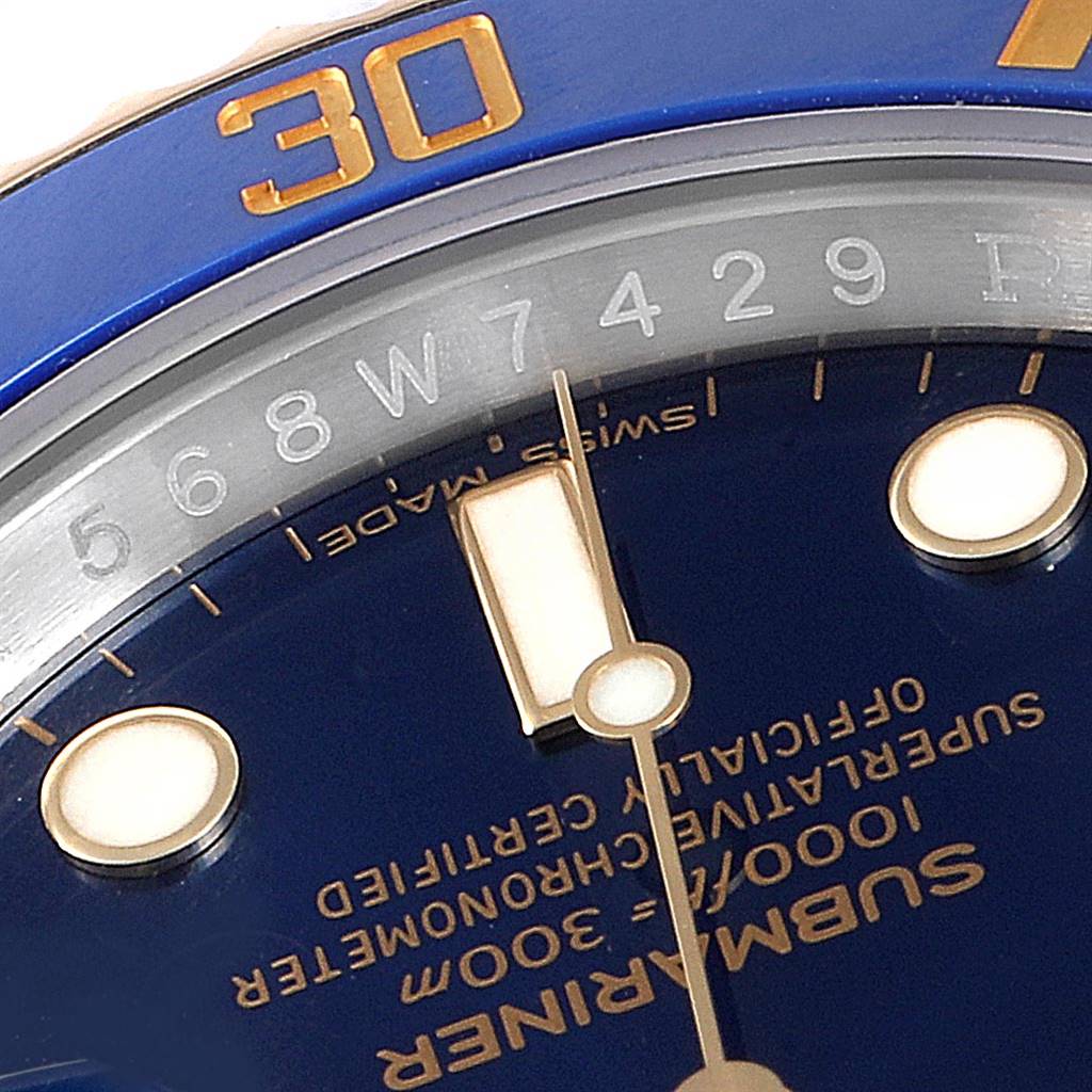 The image shows a close-up of the bezel, dial, and hands of a Rolex Submariner 116613 Men
s Steel and Gold (two tone) Blue Dial 116613 Men
s Steel and Gold (two tone) Blue Dial watch, highlighting the "30" marker and Submariner text.