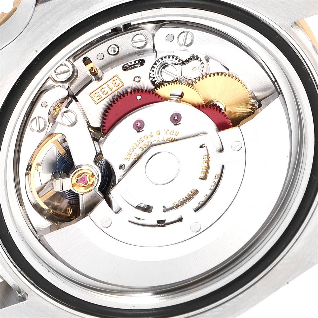 This image shows the movement mechanism of a Rolex Submariner 116613 Men
s Steel and Gold (two tone) Blue Dial 116613 Men
s Steel and Gold (two tone) Blue Dial watch from a back angle, revealing gears and internal components.
