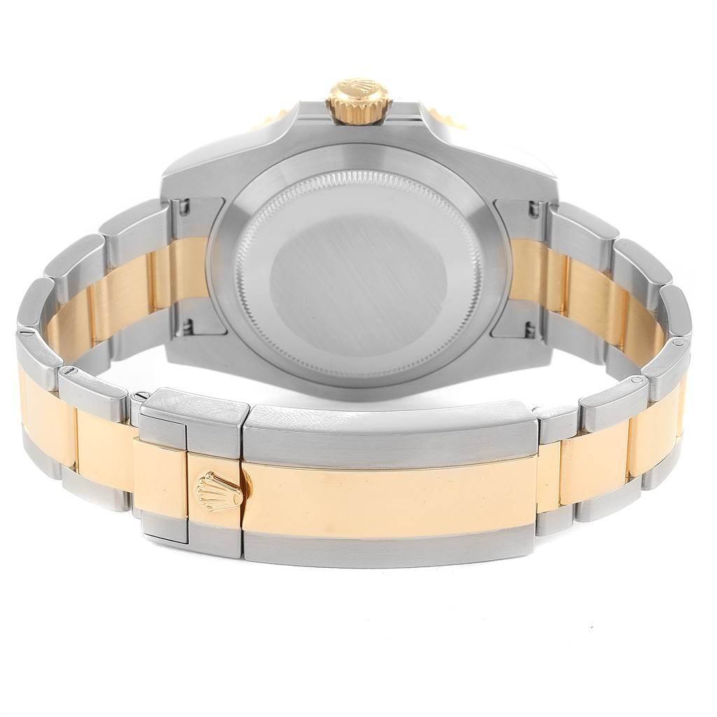 The image shows the backside of a Rolex Submariner 116613 Men
s Steel and Gold (two tone) Blue Dial 116613 Men
s Steel and Gold (two tone) Blue Dial watch, highlighting the clasp, bracelet, and case back.