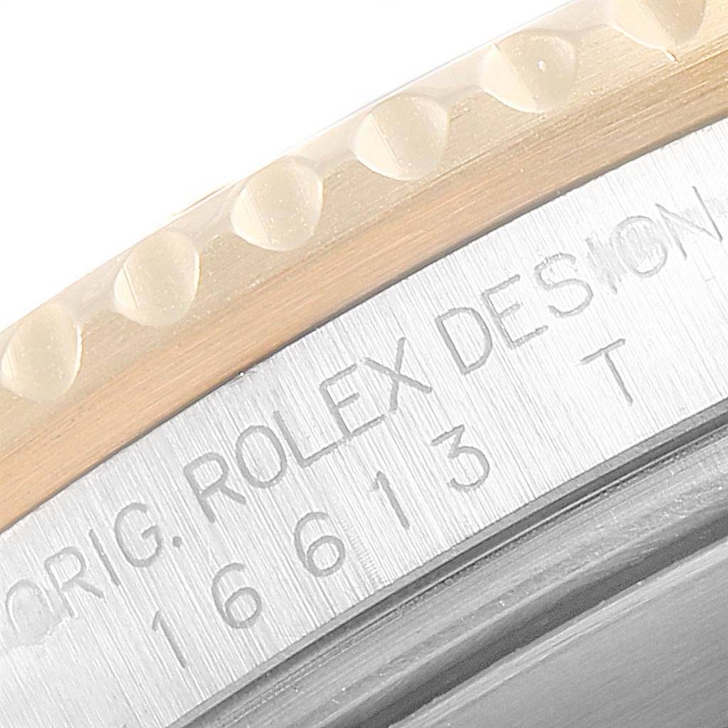 This image shows a close-up of the side engraving and the bezel of a Rolex Submariner 16613 Men
s Steel and Gold (two tone) Black Dial 16613 Men
s Steel and Gold (two tone) Black Dial watch.