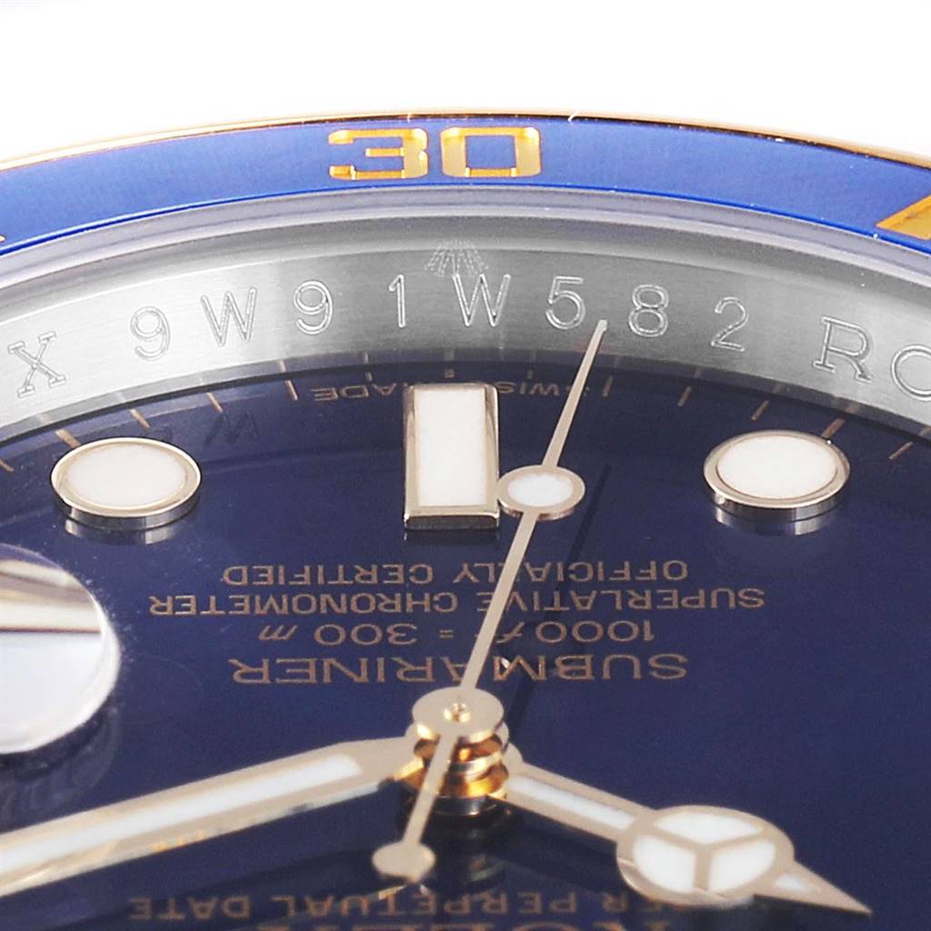 The image shows a close-up view of a Rolex Submariner 116613 Men
s Steel and Gold (two tone) Blue Dial 116613 Men
s Steel and Gold (two tone) Blue Dial watch
s dial, hands, markers, and part of the bezel with the "30" marking.