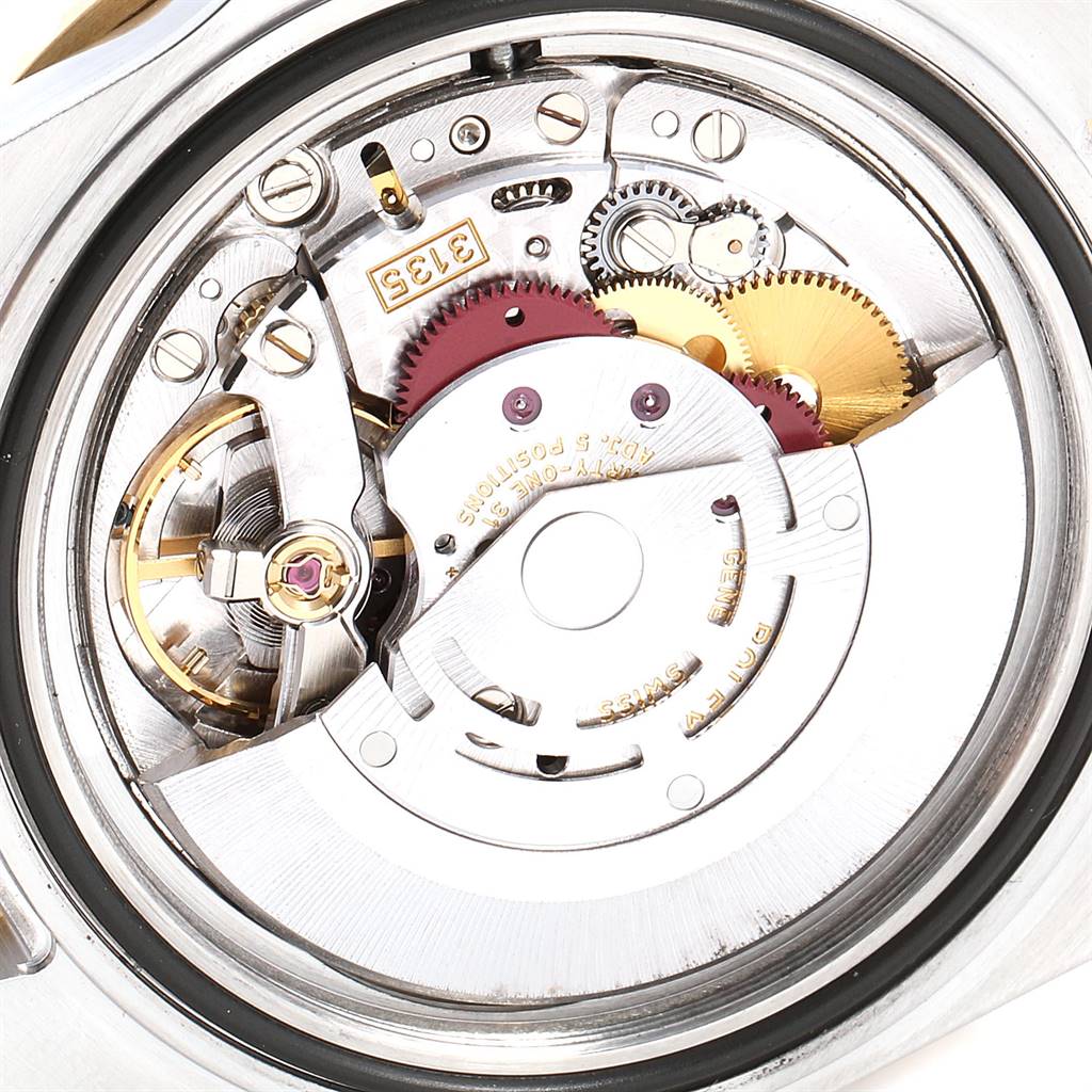 The image shows the intricate internal mechanism of the Rolex Submariner 16613 Men
s Steel and Gold (two tone) Grey Dial 16613 Men
s Steel and Gold (two tone) Grey Dial watch from a back view angle.