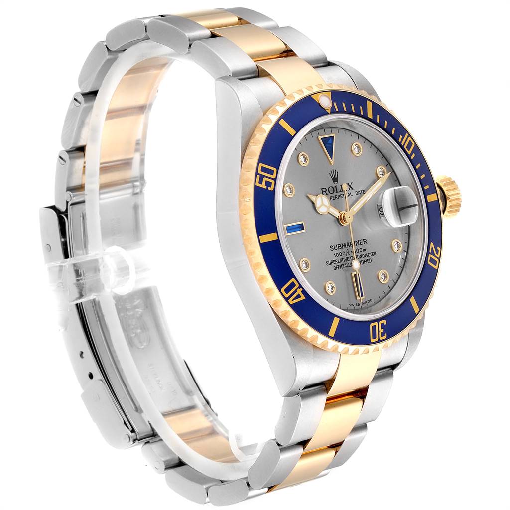 The Rolex Submariner 16613 Men
s Steel and Gold (two tone) Grey Dial 16613 Men
s Steel and Gold (two tone) Grey Dial watch is shown at a side angle, displaying its face, bezel, crown, and two-tone bracelet.