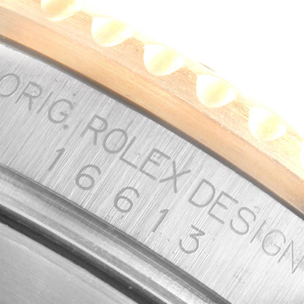 This image shows a close-up angle of the engraved case back and bezel edge of a Rolex Submariner 16613 Men
s Steel and Gold (two tone) Champagne Dial 16613 Men
s Steel and Gold (two tone) Champagne Dial, with the model number visible.