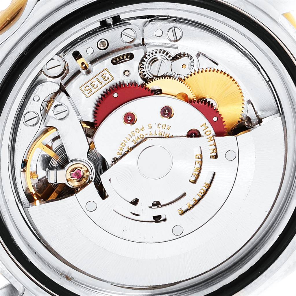 The image shows the intricate internal mechanics of a Rolex Submariner 16613 Men
s Steel and Gold (two tone) Champagne Dial 16613 Men
s Steel and Gold (two tone) Champagne Dial watch from a rear angle, highlighting gears and components.