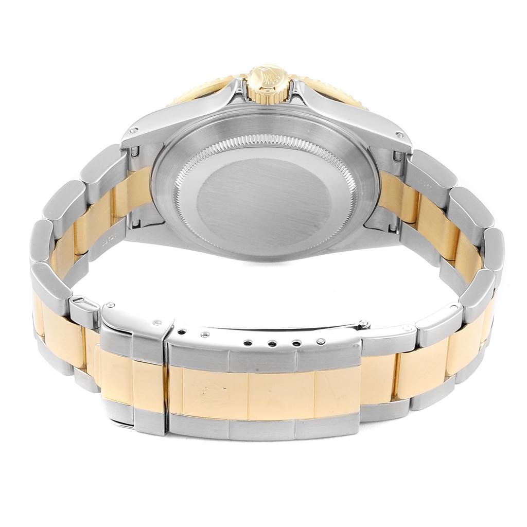 The image shows the back and the bracelet of the Rolex Submariner 16613 Men
s Steel and Gold (two tone) Champagne Dial 16613 Men
s Steel and Gold (two tone) Champagne Dial watch, highlighting its two-tone design.