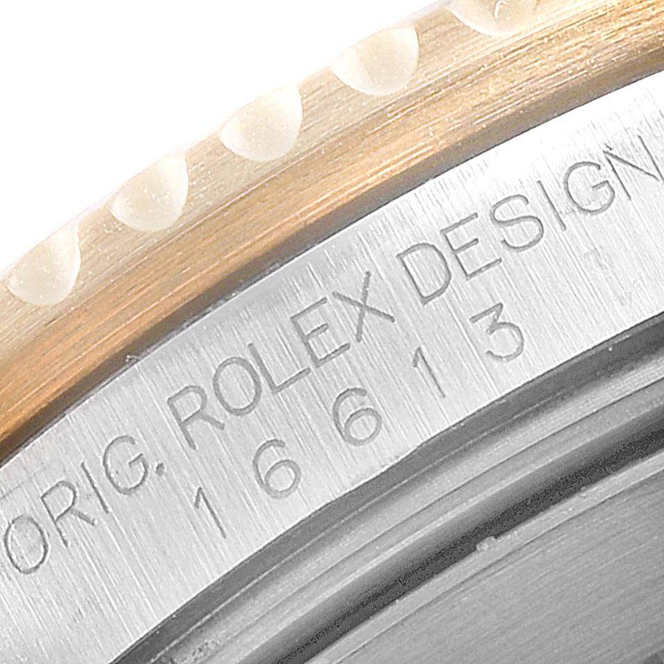 This close-up shows the edge of the bezel and case back, featuring the model and branding of the Rolex Submariner 16613 Men
s Steel and Gold (two tone) Blue Dial 16613 Men
s Steel and Gold (two tone) Blue Dial.