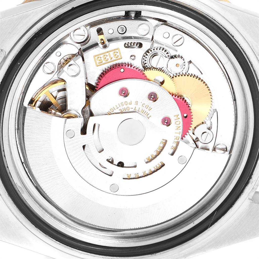 The image shows the internal mechanism and movement parts of a Rolex Submariner 16613 Men
s Steel and Gold (two tone) Blue Dial 16613 Men
s Steel and Gold (two tone) Blue Dial watch from a rear angle.
