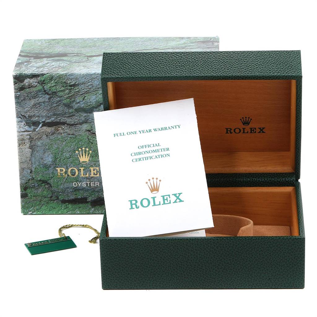 The image shows an open Submariner Rolex watch box with a warranty card and certification paper inside.