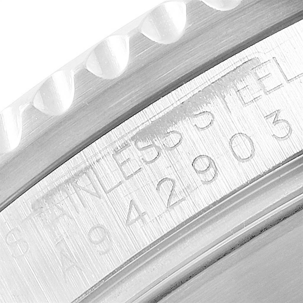 The image shows a close-up of the side of a Rolex Submariner 16610 Men
s Stainless Steel Black Dial 16610 Men
s Stainless Steel Black Dial watch, highlighting the model
s serial number and part of the bezel.