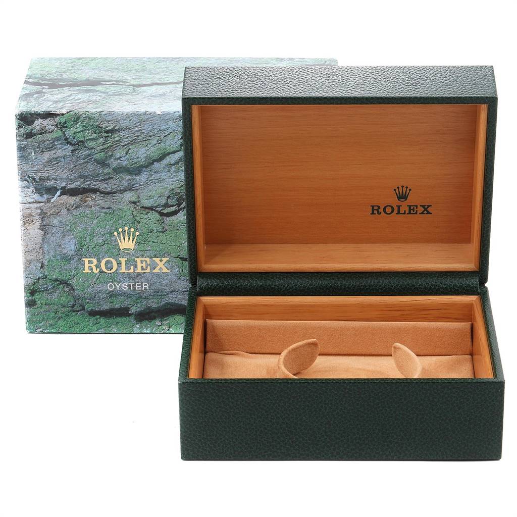 The image shows an open green and wooden Rolex Submariner 16610 Men
s Stainless Steel Black Dial 16610 Men
s Stainless Steel Black Dial watch box with the outer packaging behind it.