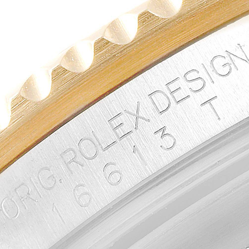 This close-up image of a Rolex Submariner 16613 Men
s Steel and Gold (two tone) Blue Dial 16613 Men
s Steel and Gold (two tone) Blue Dial watch shows the engraved details on the side of the watch case.