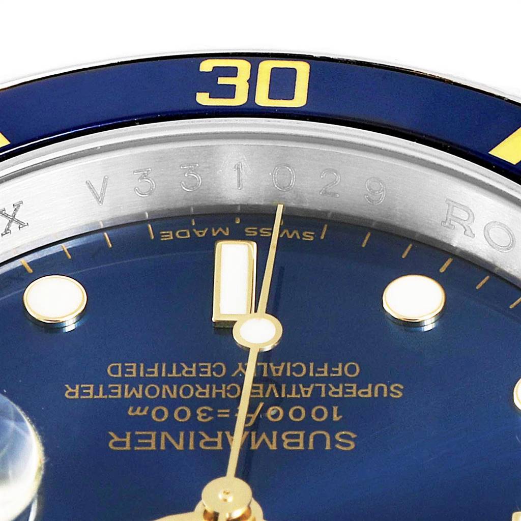 This image shows a close-up of the face, bezel, and serial number engraving of a Rolex Submariner 16613 Men
s Steel and Gold (two tone) Blue Dial 16613 Men
s Steel and Gold (two tone) Blue Dial watch.