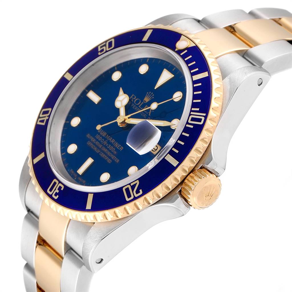 This image shows a close-up angle of a Rolex Submariner 16613 Men
s Steel and Gold (two tone) Blue Dial 16613 Men
s Steel and Gold (two tone) Blue Dial watch featuring its blue dial, bezel, crown, and part of its two-tone metal bracelet.