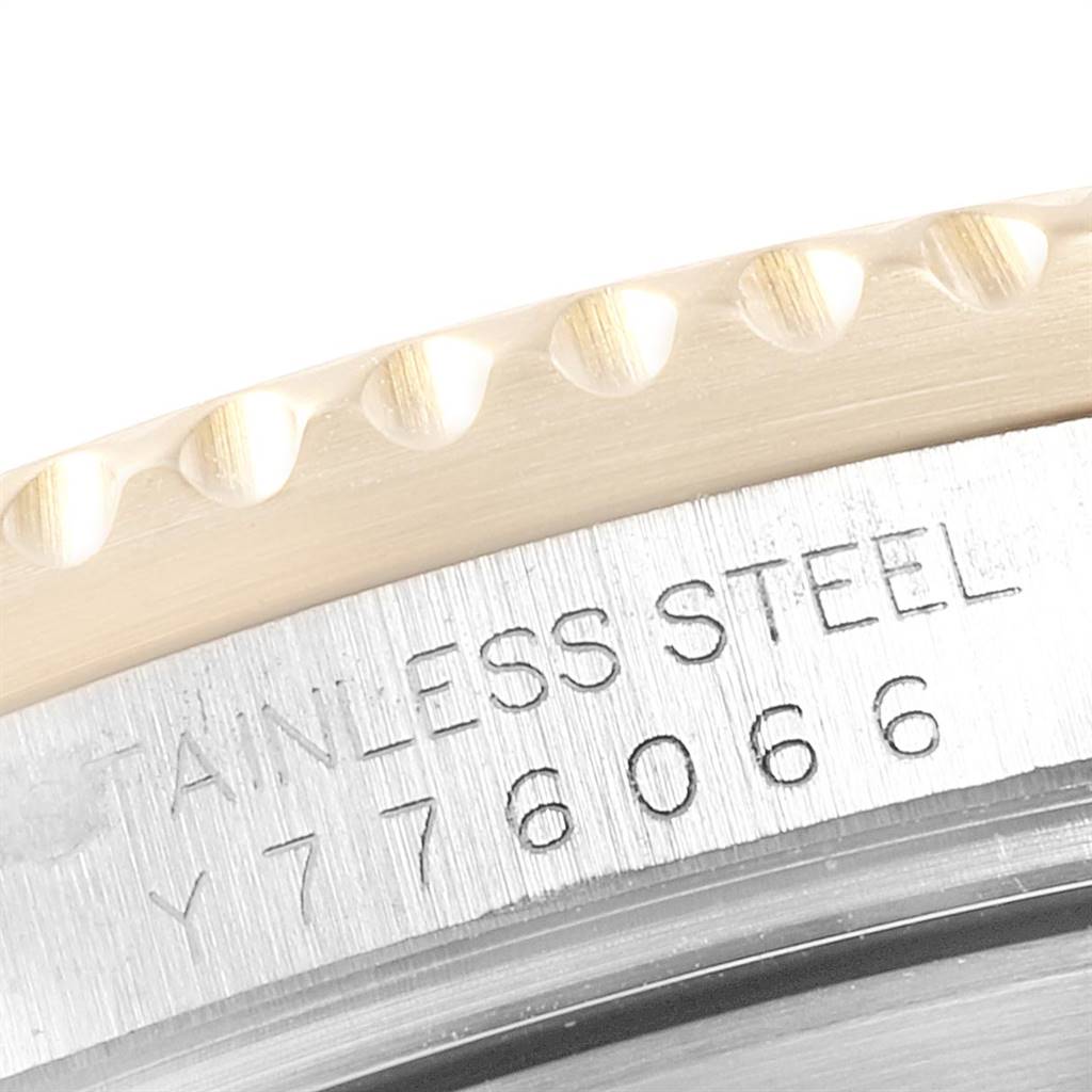 The image shows a close-up of the case back of a Rolex Submariner 16613 Men
s Steel and Gold (two tone) Blue Dial 16613 Men
s Steel and Gold (two tone) Blue Dial watch, highlighting the stainless steel material and serial number engraved.