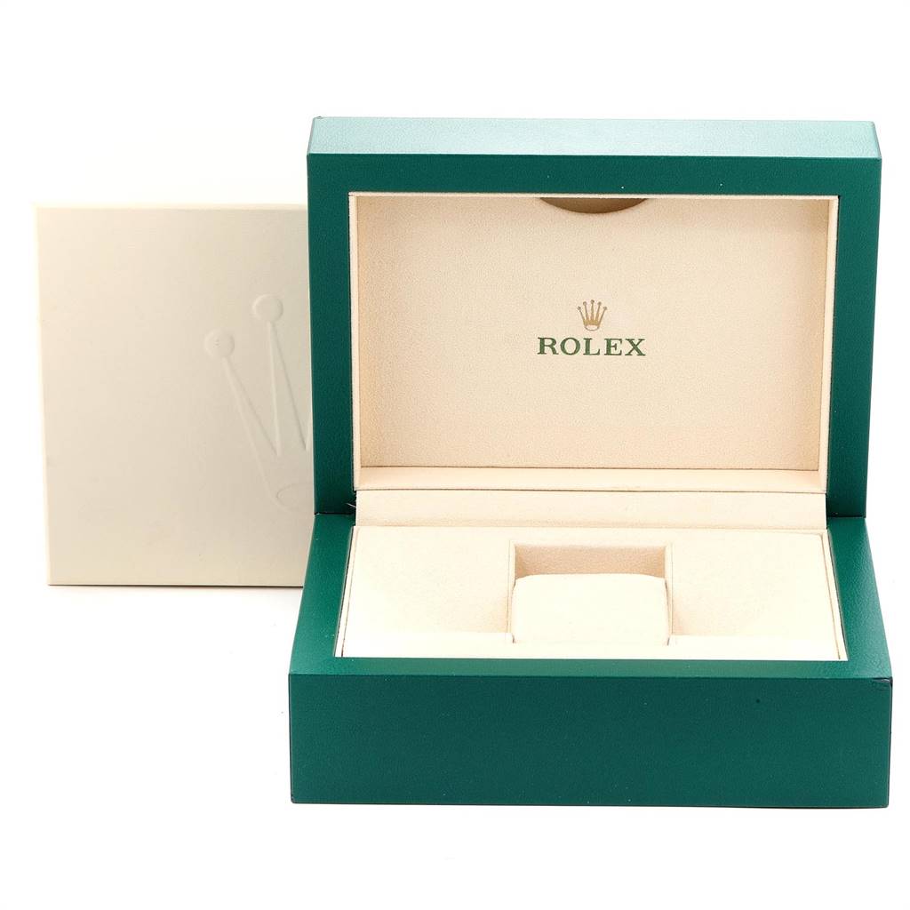 This image shows an open, empty green and beige Rolex box for the Submariner model, with a removable inner cushion.
