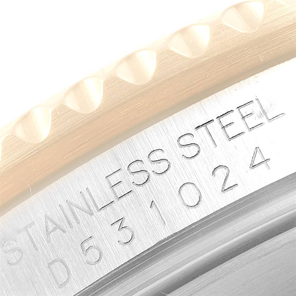 The image shows a close-up of the case back edge on the Rolex Submariner 16613 Men
s Steel and Gold (two tone) Black Dial 16613 Men
s Steel and Gold (two tone) Black Dial, highlighting the stainless steel material and engraved serial number.