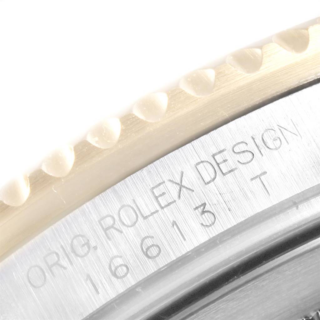 Close-up of the Rolex Submariner 16613 Men
s Steel and Gold (two tone) Black Dial 16613 Men
s Steel and Gold (two tone) Black Dial model showing the engraved design and model number on the bezel.