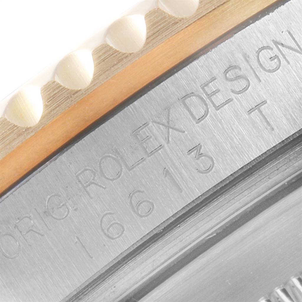 This image shows a close-up of the side engraving on the bezel and case of a Rolex Submariner 16613 Men
s Steel and Gold (two tone) Blue Dial 16613 Men
s Steel and Gold (two tone) Blue Dial watch.