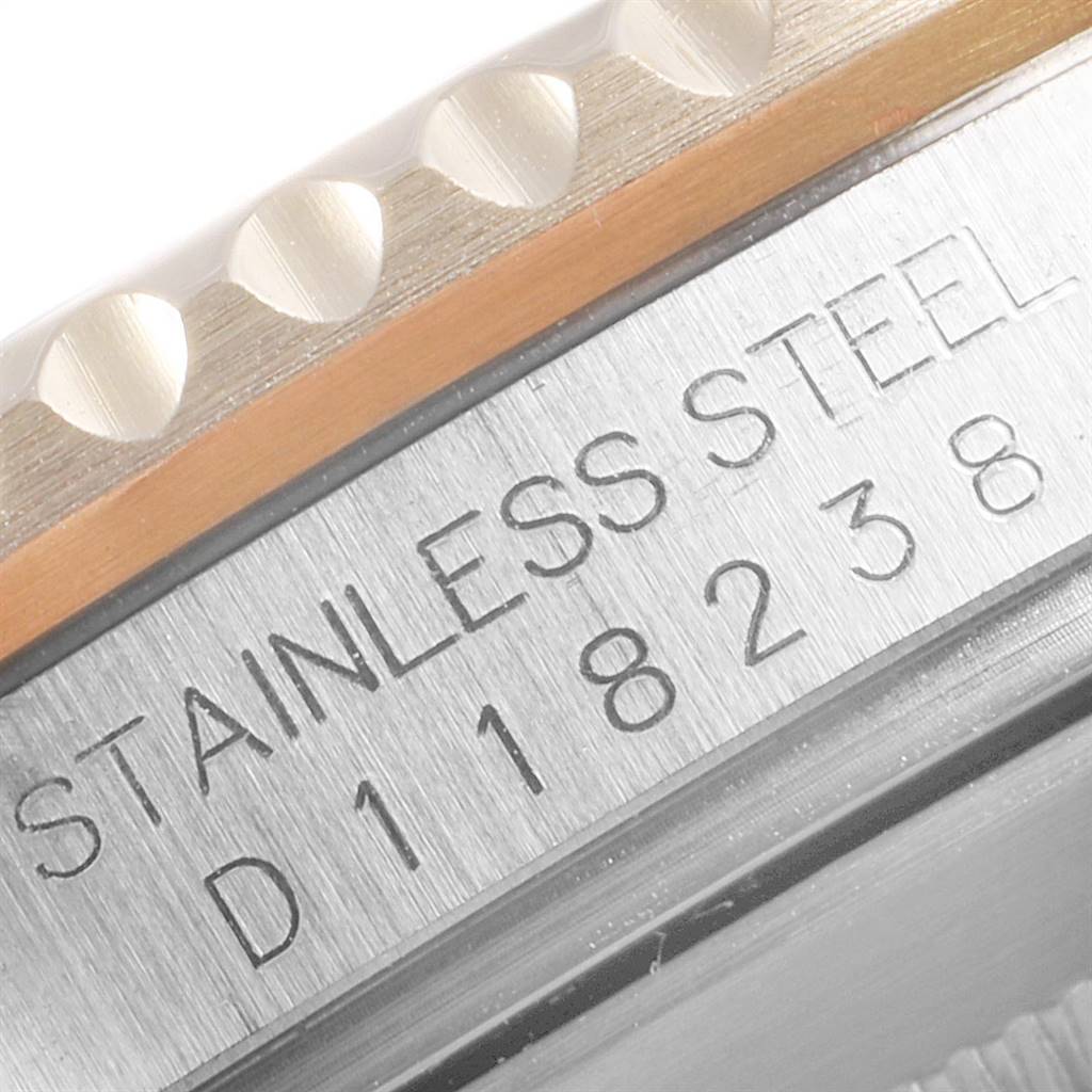 The image shows a close-up of the case side markings and bezel of a Rolex Submariner 16613 Men
s Steel and Gold (two tone) Blue Dial 16613 Men
s Steel and Gold (two tone) Blue Dial watch, highlighting the "Stainless Steel" engraving.