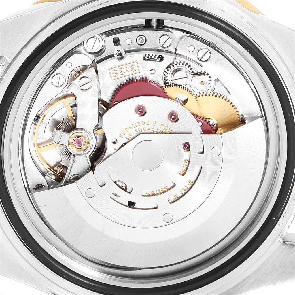 The image shows the internal mechanical movement of a Rolex Submariner 16613 Men
s Steel and Gold (two tone) Blue Dial 16613 Men
s Steel and Gold (two tone) Blue Dial watch viewed from the back.