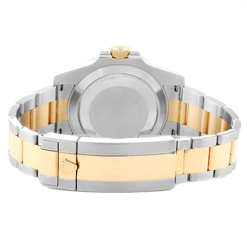 The image shows the back view of a Rolex Submariner 116613 Men
s Steel and Gold (two tone) Black Dial 116613 Men
s Steel and Gold (two tone) Black Dial watch, highlighting the case back and the two-tone bracelet.