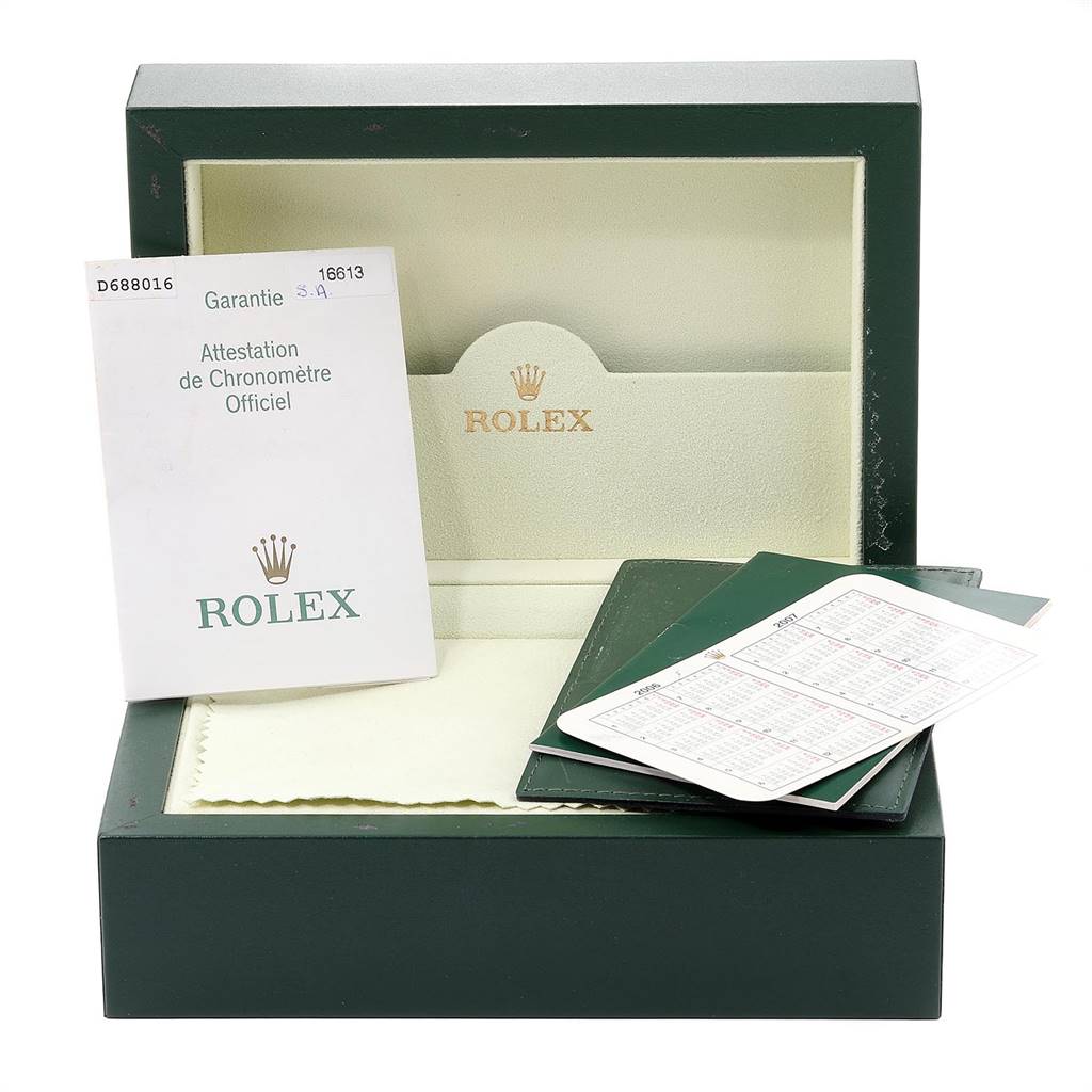 This image shows the box, warranty card, and documentation for the Rolex Submariner 16613 Men
s Steel and Gold (two tone) Blue Dial 16613 Men
s Steel and Gold (two tone) Blue Dial watch.