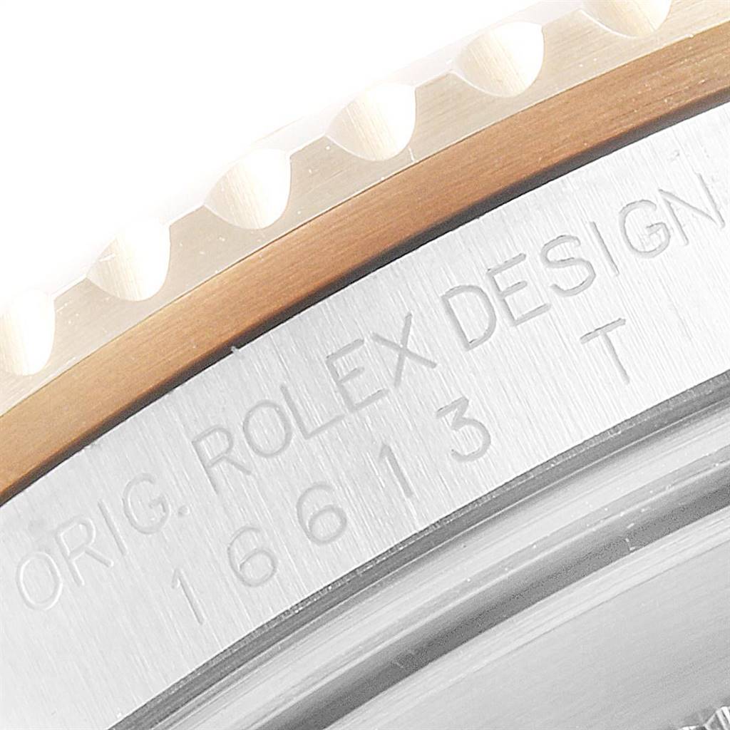 The image shows a close-up of the model number and design engraving on the side of a Rolex Submariner 16613 Men
s Steel and Gold (two tone) Blue Dial 16613 Men
s Steel and Gold (two tone) Blue Dial
s case and bezel.