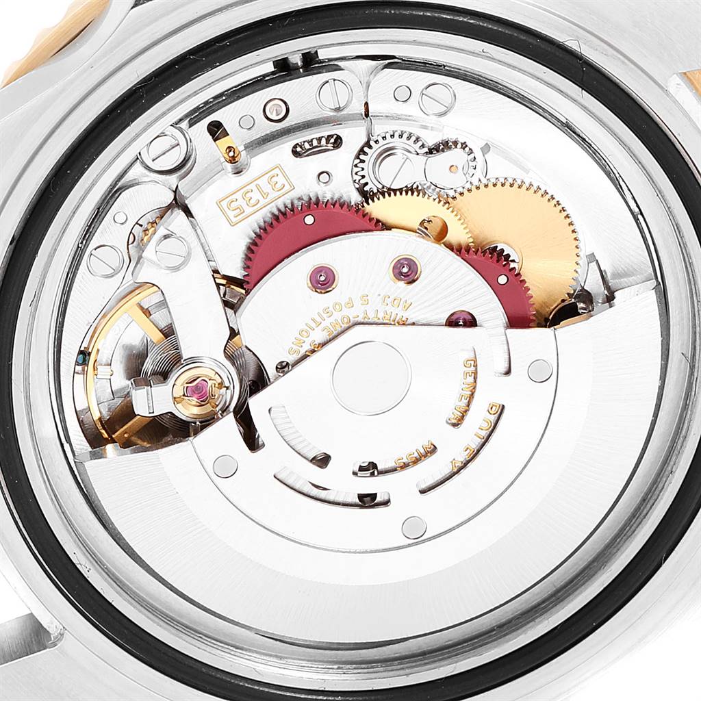 The image shows the internal mechanism of a Rolex Submariner 16613 Men
s Steel and Gold (two tone) Blue Dial 16613 Men
s Steel and Gold (two tone) Blue Dial watch viewed from the back.