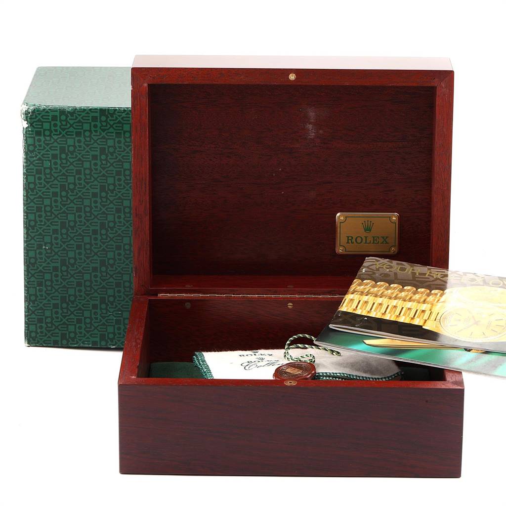 This image shows a Rolex Submariner 16618 Men's Yellow Gold Blue Dial 16618 Men's Yellow Gold Blue Dial watch accessory set, including an open wooden box, certification, and booklets.