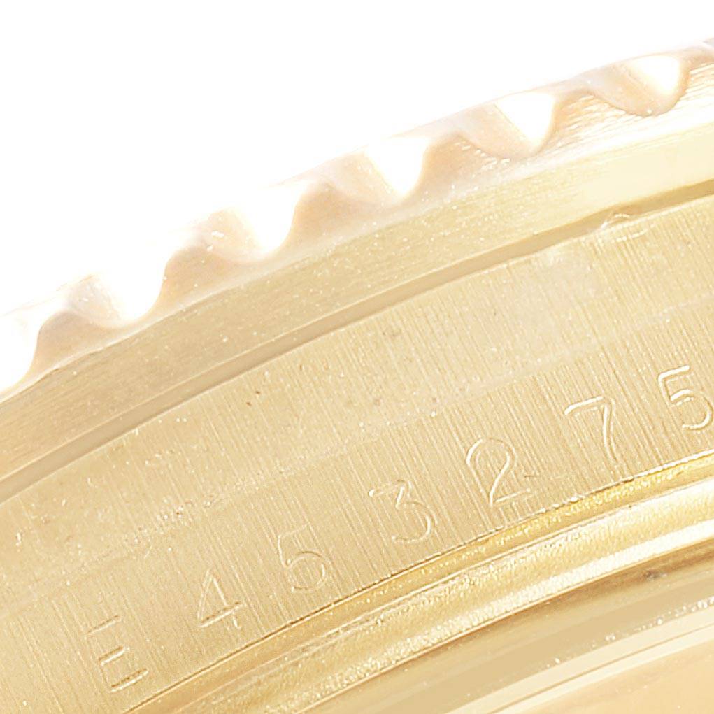 This close-up image shows the textured edge and engraved serial number of a Rolex Submariner 16618 Men's Yellow Gold Blue Dial 16618 Men's Yellow Gold Blue Dial watch.