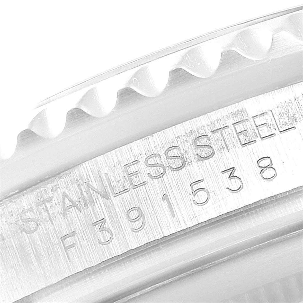 The image shows a close-up of the edge and serial number engravings on the bezel and case of a Rolex Submariner 16610LV Men
s Stainless Steel Black Dial 16610LV Men
s Stainless Steel Black Dial watch.