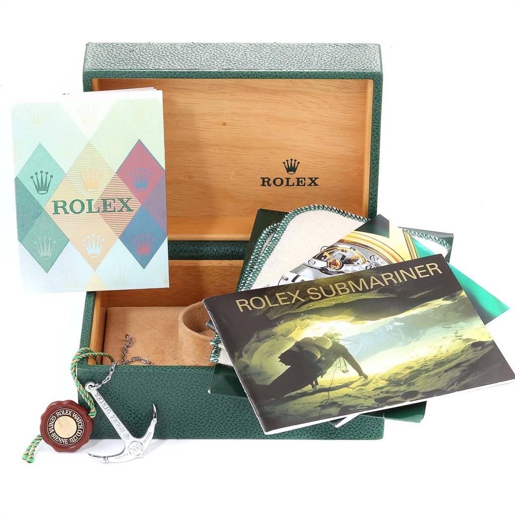 The image shows a Rolex Submariner 16610LV Men
s Stainless Steel Black Dial 16610LV Men
s Stainless Steel Black Dial watch box, manuals, tags, and accessories from an aerial angle.