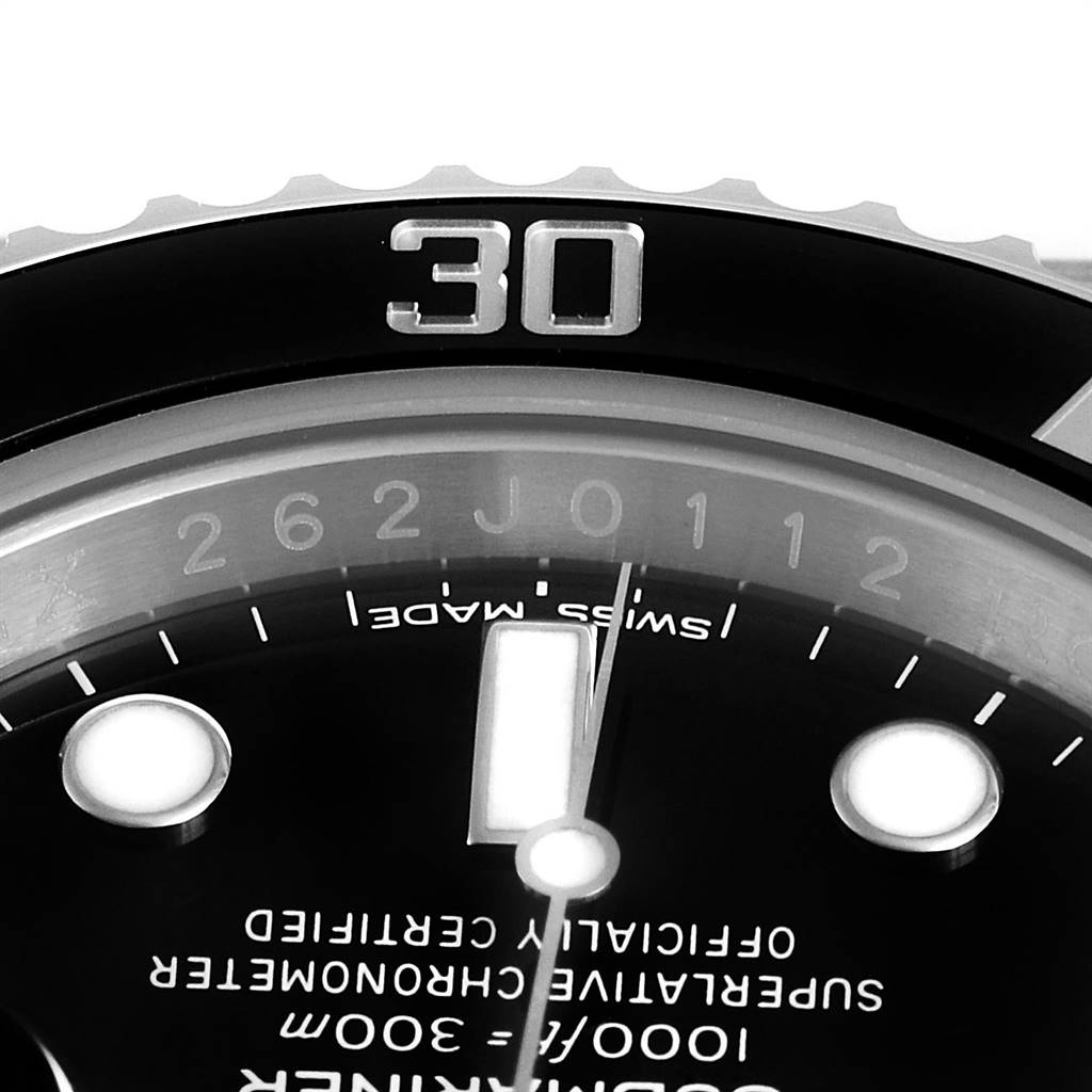 This close-up image of a Rolex Submariner 116610 Men
s Stainless Steel Black Dial 116610 Men
s Stainless Steel Black Dial watch shows the bezel at the 30-minute mark and part of the dial with luminescent markers.