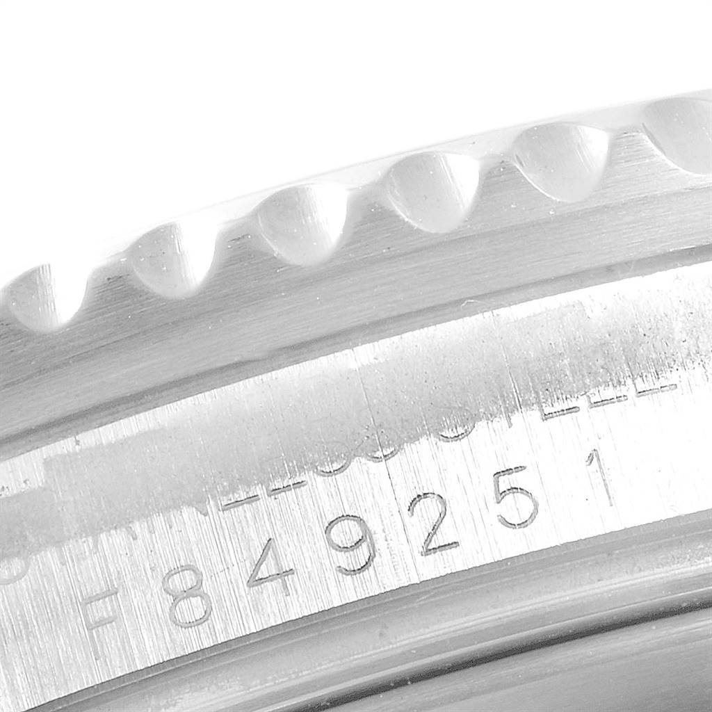 The image shows a close-up of the Rolex Submariner 16610 Men
s Stainless Steel Black Dial 16610 Men
s Stainless Steel Black Dial
s case with visible serial numbers.