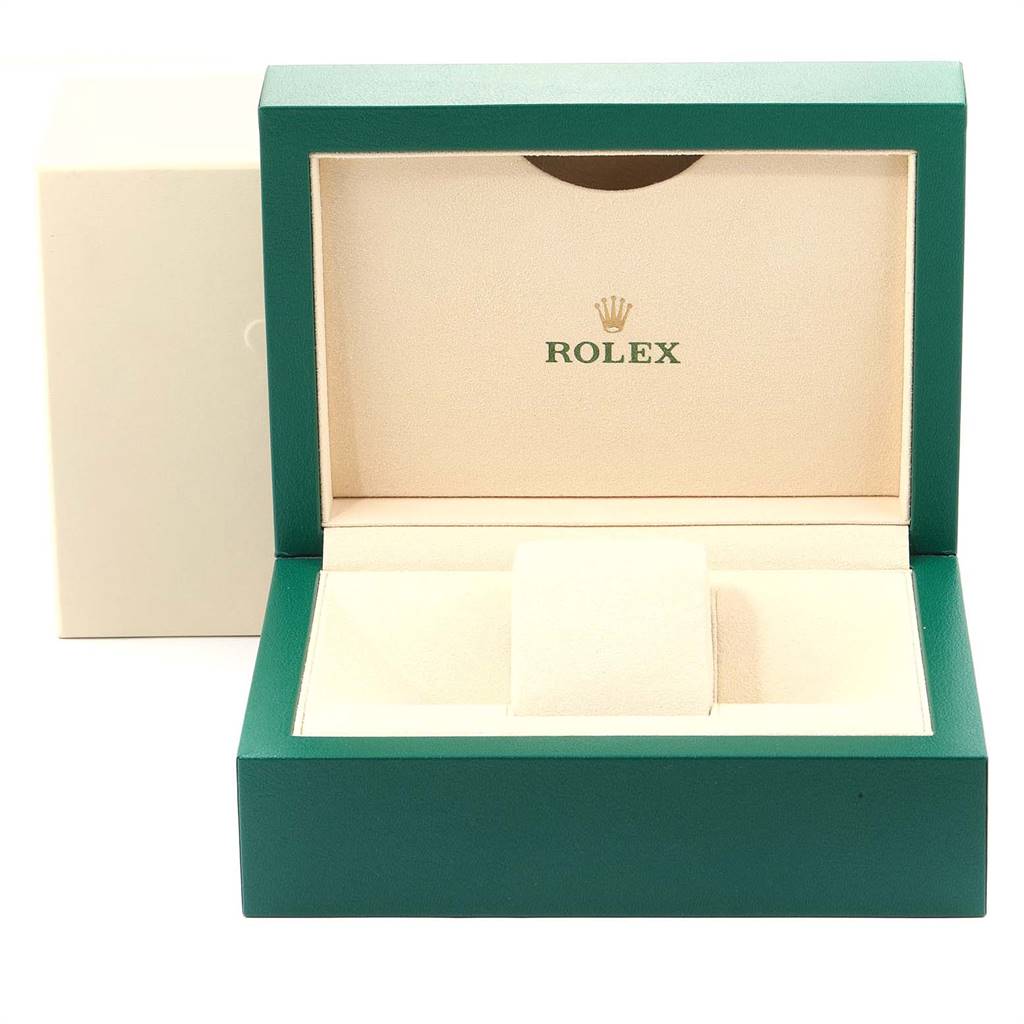 The image shows an open green and cream Rolex box for a Submariner watch.