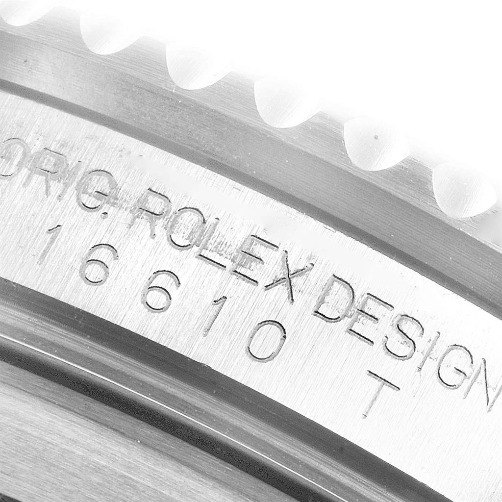 The image shows a close-up of the side of a Rolex Submariner 16610 Men
s Stainless Steel Black Dial 16610 Men
s Stainless Steel Black Dial watch, focusing on the engraved model number 16610T.