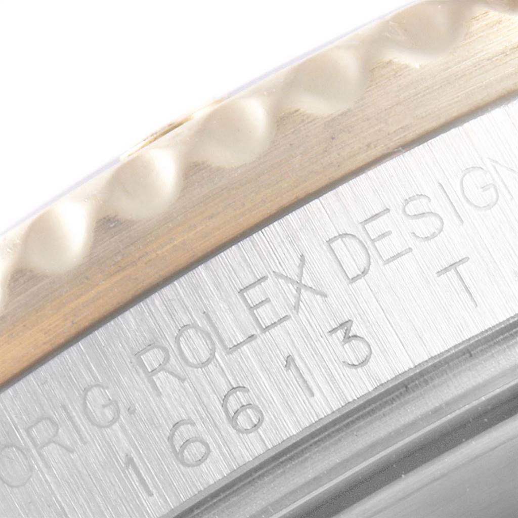 This close-up angle shows part of the bezel and the engraved text on the case of the Rolex Submariner 16613 Men
s Steel and Gold (two tone) Blue Dial 16613 Men
s Steel and Gold (two tone) Blue Dial watch.