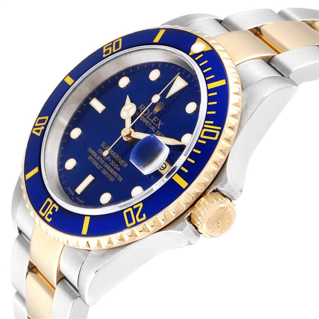 The image shows a Rolex Submariner 16613 Men
s Steel and Gold (two tone) Blue Dial 16613 Men
s Steel and Gold (two tone) Blue Dial watch from an angled close-up, focusing on the bezel, dial, crown, and part of the bracelet.