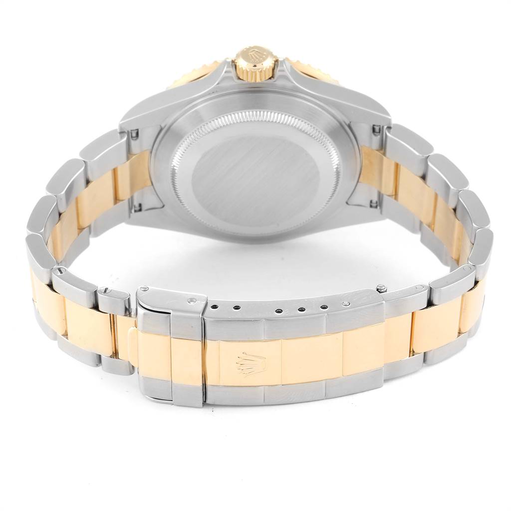 The image shows the back of a Rolex Submariner 16613 Men's Steel and Gold (two tone) Black Dial 16613 Men's Steel and Gold (two tone) Black Dial watch, highlighting its case back and two-tone bracelet with a clasp.