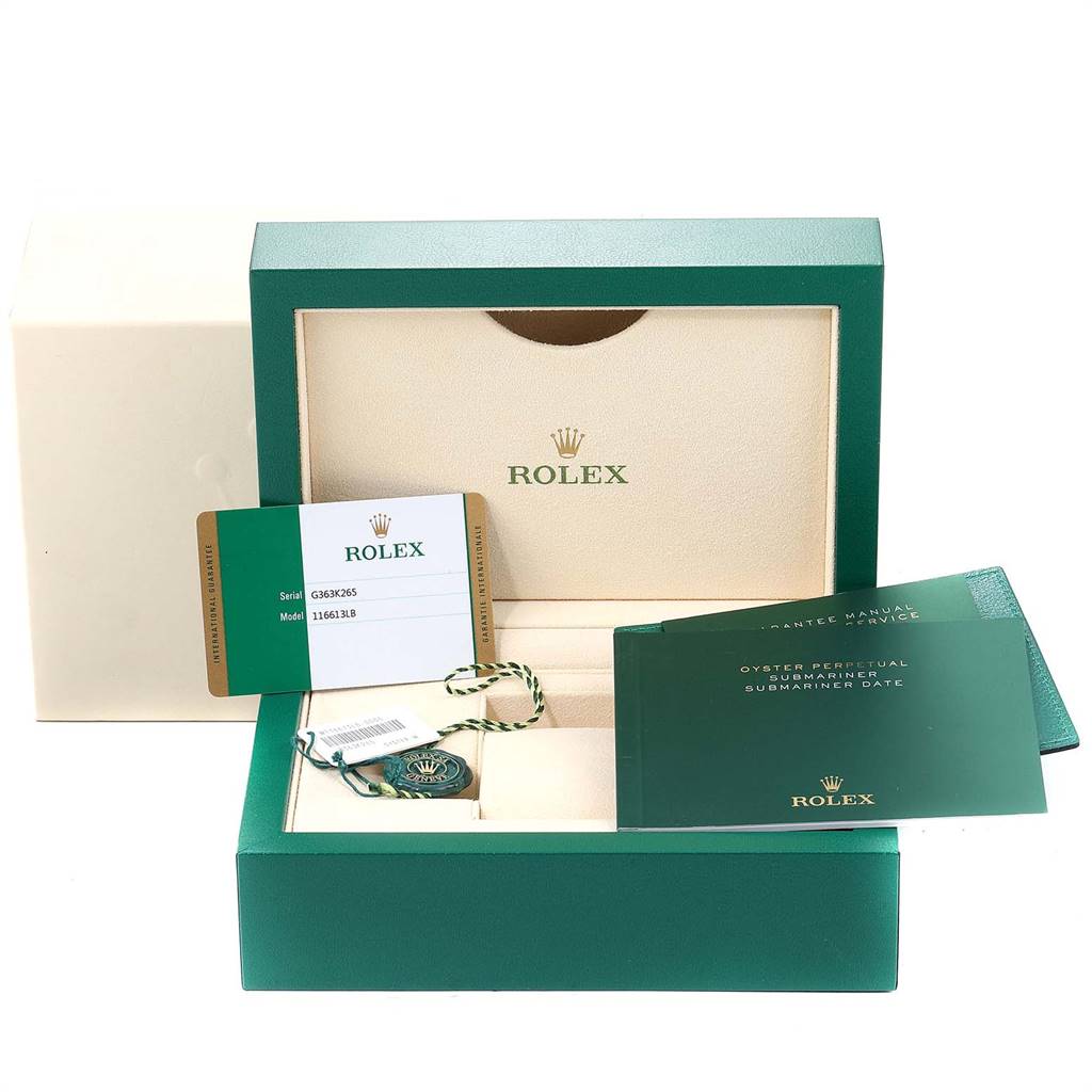 The image shows the packaging, warranty card, manuals, and tags for a Rolex Submariner 116613 Men
s Steel and Gold (two tone) Blue Dial 116613 Men
s Steel and Gold (two tone) Blue Dial watch, all from a frontal angle.